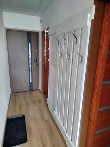 an empty room with a hallway with a stair case at Apartmán Lhota in Náchod