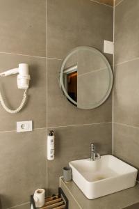 a bathroom with a sink and a mirror at DejaVu Hotel in Prizren +25 photos