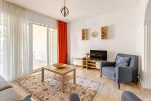 a living room with a couch and a chair and a table at Güneş Villa in Antalya