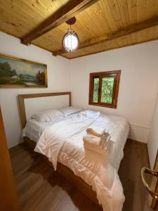 a bedroom with a large white bed in a room at Vila Kadiu in Klos