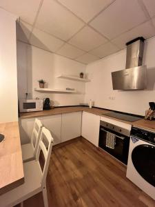 a kitchen with white cabinets and a stove top oven at Casa Portalet in Xàtiva