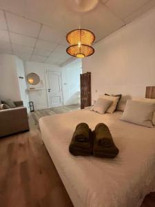 a bedroom with a large bed with two slippers on it at Casa Portalet in Xàtiva