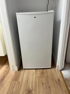 a white refrigerator in the corner of a room at Casa Portalet in Xàtiva
