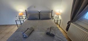 a bedroom with a bed with two pairs of socks on it at MaryAnn's house in Livadi