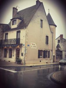 a large white building with a sign on the side of a street at l'authentique in Saint-Amand-Montrond