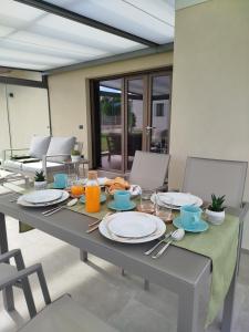 a table with plates of food and orange juice on it at Il Giardino di Sofia B&B in Piozzo
