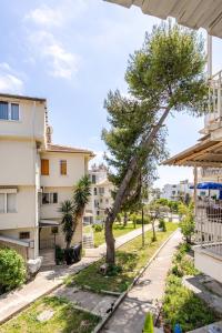 a view from the balcony of a apartment with a tree at Güneş Villa in Antalya
