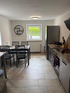 a kitchen and dining room with a table and chairs at FeWo Johann Friedrich in Hilpoltstein