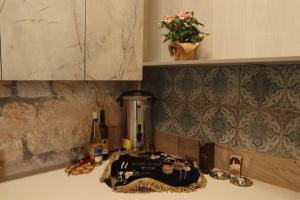 a counter top with a bottle of wine and a blender at The Essence in Safed