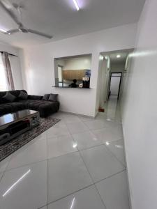 a living room with a couch and a mirror at Blossom Homes A2 in Mombasa