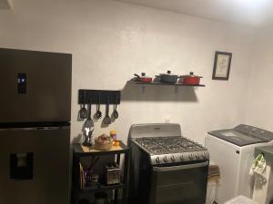 a kitchen with a stove and a counter with utensils at Casa Cangrejos in Cabo San Lucas