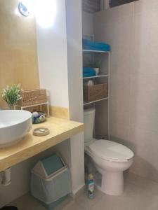 a bathroom with a white toilet and a sink at Casa Cangrejos in Cabo San Lucas +9 photos