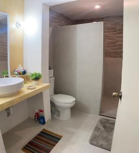 a bathroom with a toilet and a sink and a shower at Casa Cangrejos in Cabo San Lucas