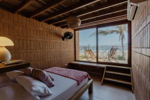 a bedroom with a window with a view of the beach at Costeño Beach in Santa Marta +63 photos