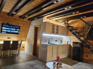 a kitchen with a staircase in a room at Brvnare na Oku Zlatibor in Ocka Gora