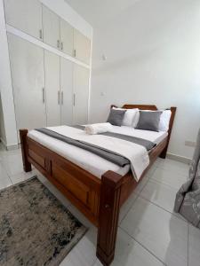 a bedroom with a large bed in a room at Blossom Homes A2 in Mombasa