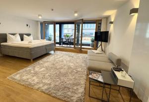 a living room with a bed and a couch at AltstadtOase in Konstanz