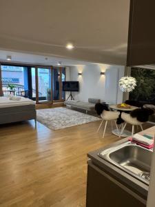 a kitchen and living room with a couch and a table at AltstadtOase in Konstanz
