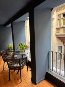 a balcony with a table and chairs in a building at AltstadtOase in Konstanz