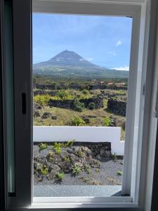 a view of a mountain through a window at Casa Dos Arcos Oceanfront Apartments in Arcos