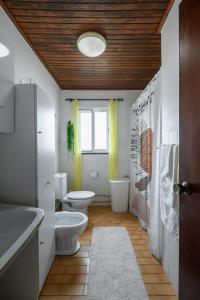a bathroom with a toilet and a sink at Casa Dos Arcos Oceanfront Apartments in Arcos