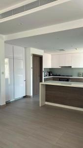 a large kitchen with white cabinets and a counter top at Home Sweet Home in Abu Dhabi