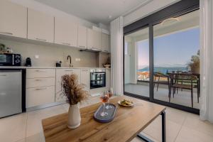 a kitchen with a table with two glasses of wine at Pillow Apartments in Nikiana