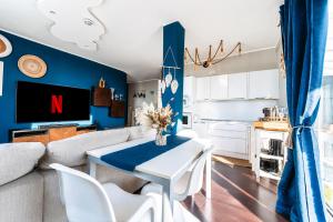 a living room with a couch and a table at Suite Apartments Rimini - Seafront in Rimini