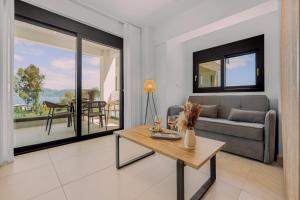 a living room with a couch and a table at Pillow Apartments in Nikiana