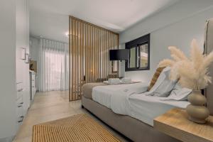 a bedroom with a large bed and a window at Pillow Apartments in Nikiana