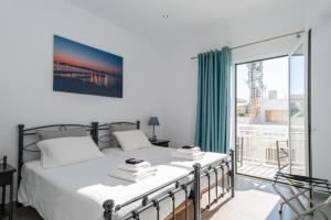 a bedroom with two beds and a large window at Milva Apartments in Kos