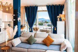 a living room with a couch and a large window at Suite Apartments Rimini - Seafront in Rimini