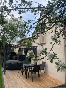 a patio with a table and chairs on a wooden deck at Polna 31 in Olsztyn