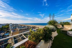 a balcony with a view of the beach at Suite Apartments Rimini - Seafront in Rimini
