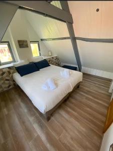 a bedroom with a large bed in a attic at Cottage de la Maye in Rue