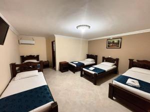 a hotel room with three beds and a room with twothirds at Delfin Hotel Collection Rodadero in Rodadero