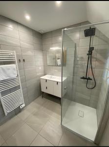 a bathroom with a shower and a sink at Cottage de la Maye in Rue +33 photos