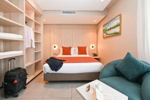 a hotel room with a bed and a couch at Aruba Casablanca City Center in Casablanca