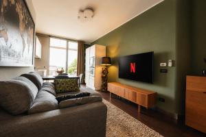 a living room with a couch and a tv at Suite Apartments Rimini - Seafront in Rimini +42 photos