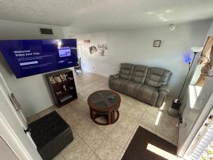 a living room with a couch and a tv at Plum Cozy Spot in Seffner