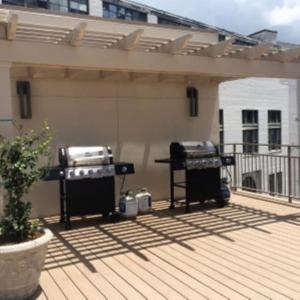 a patio with two bbqs and a grill at Suite Bleu 5 Min walk to Bourbon st Rooftop Pool in New Orleans