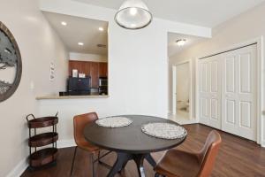 a kitchen and dining room with a table and chairs at Suite Bleu 5 Min walk to Bourbon st Rooftop Pool in New Orleans +15 photos