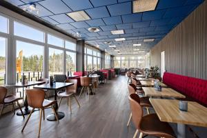 a restaurant with tables and chairs and windows at Best Western Eskilstuna Arena Hotel in Eskilstuna +22 photos