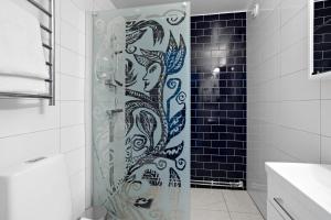 a shower with a glass door in a bathroom at Best Western Eskilstuna Arena Hotel in Eskilstuna