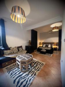 a living room with a couch and a zebra rug at Hotel tafoukt in Marrakesh +3 photos