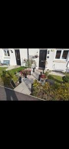 a view of a house with flowers in a yard at edinburgh holiday home in Roslin