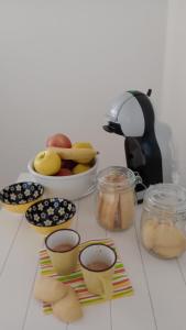 a table topped with cookies and a bowl of fruit at B&B Il Nocciolino in La Fabbrica
