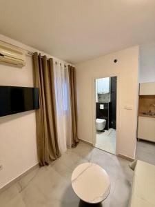 a living room with a table and a toilet in it at Vila Lavandel in Bečići