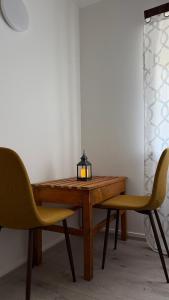 a wooden table with two chairs and a lamp on it at Ocean View Guesthouse in Borgarnes +44 photos