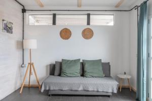 a bedroom with a bed in a white wall at Suite Junior Amanecer in Mácher +13 photos